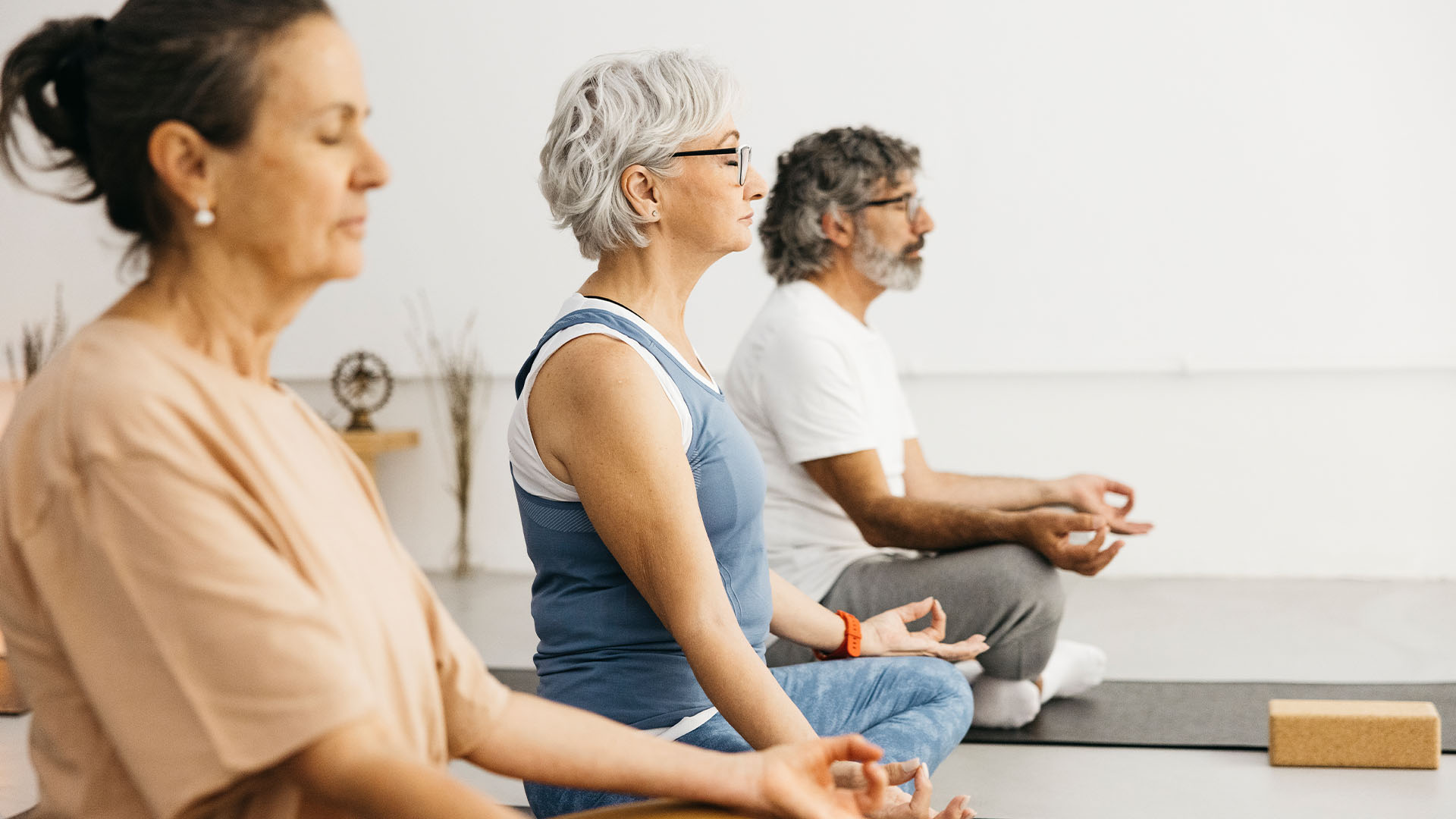 Group of people meditating in an exercise studio