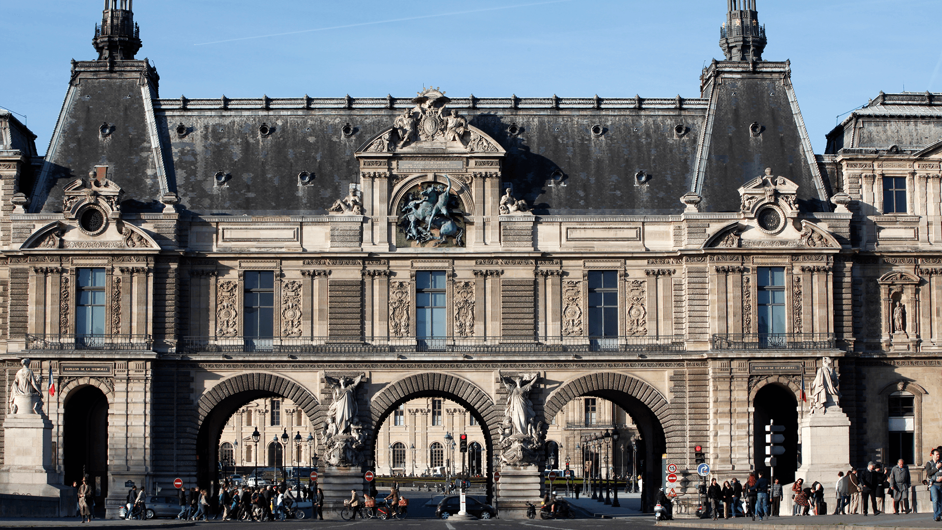 Louvre Palace exterior with arched passageways