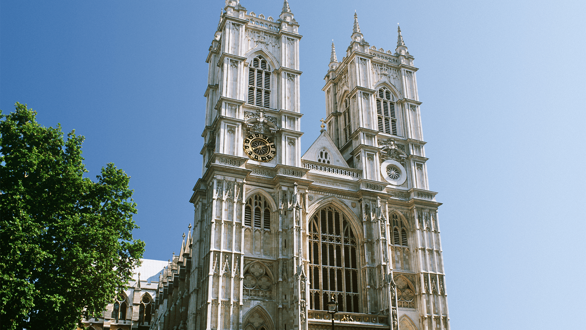 Ornate exterior of Westminster Abbey under a blue sky