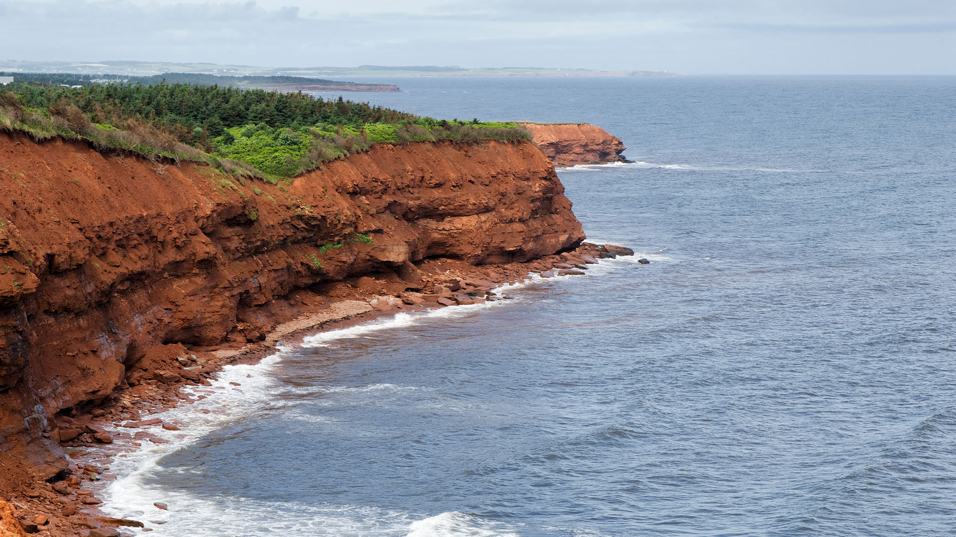 Eroded oceanside red sandstone cliffs