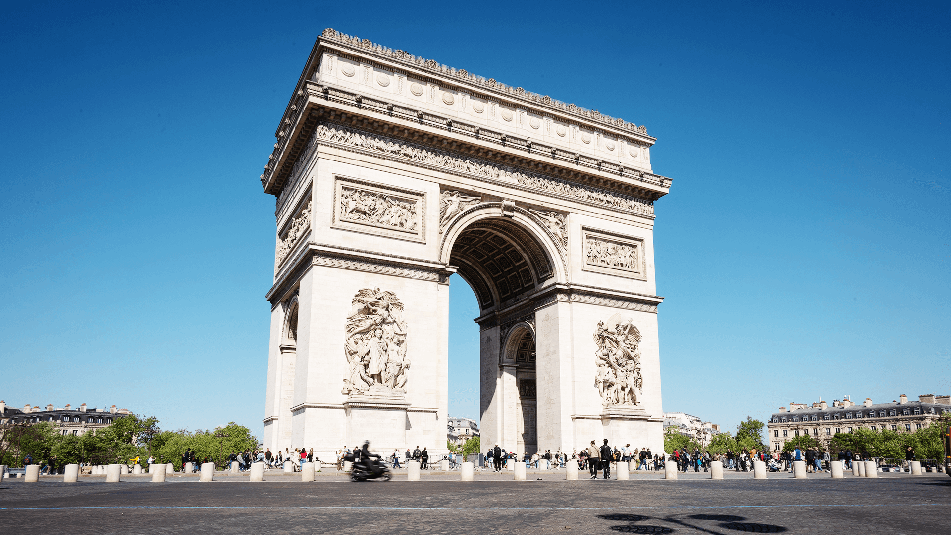 The Arc de Triomphe under a clear blue sky