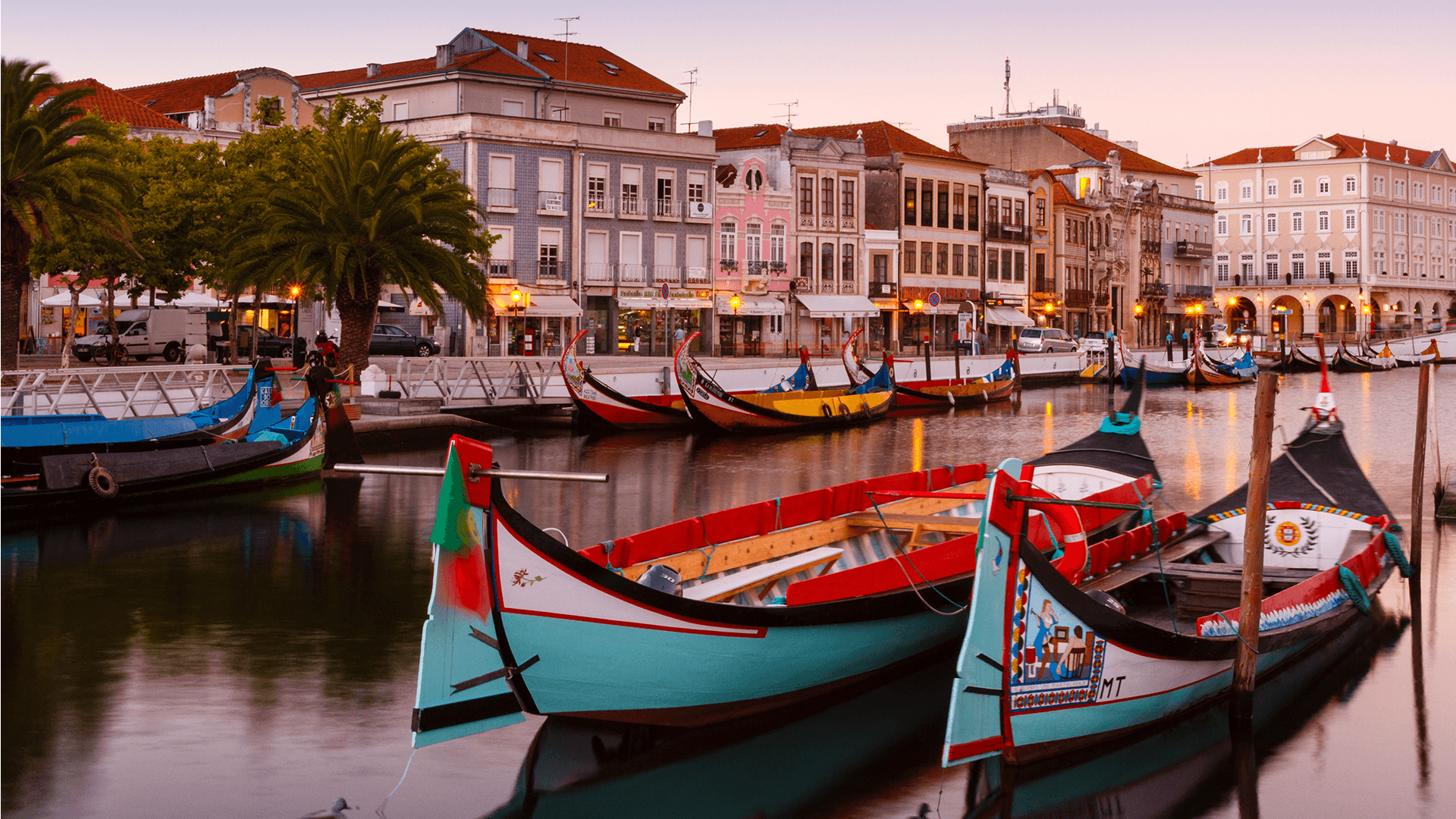 Multicoloured wooden boats moored in a canal