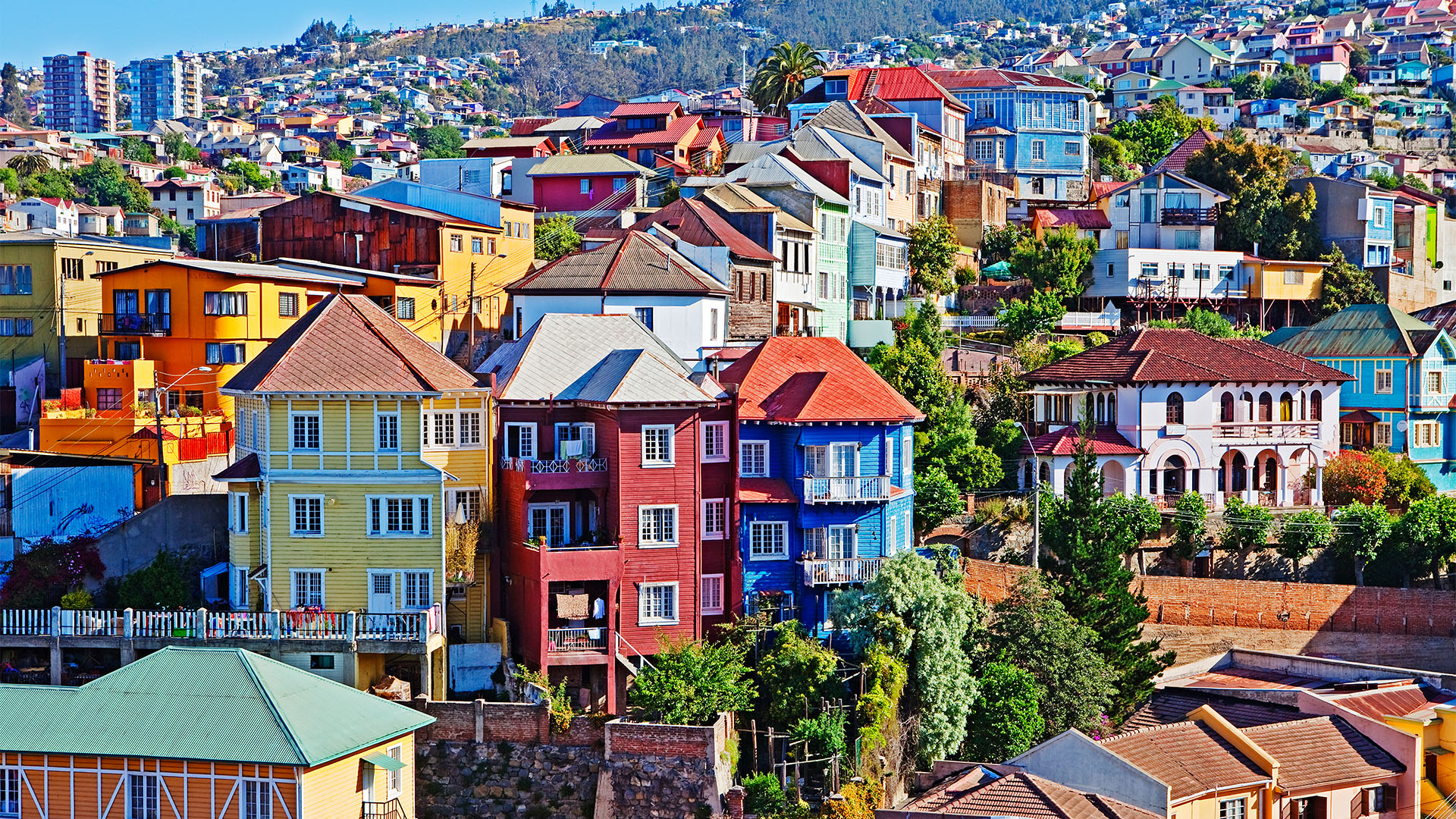 Multicoloured buildings rising along a steep hill