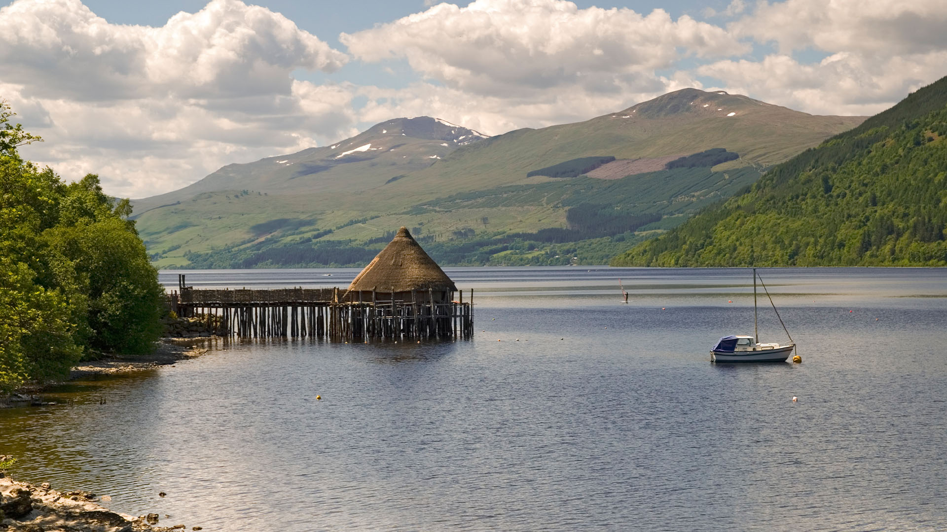 Thatched roof hut on stilts over the water in Loch Tay