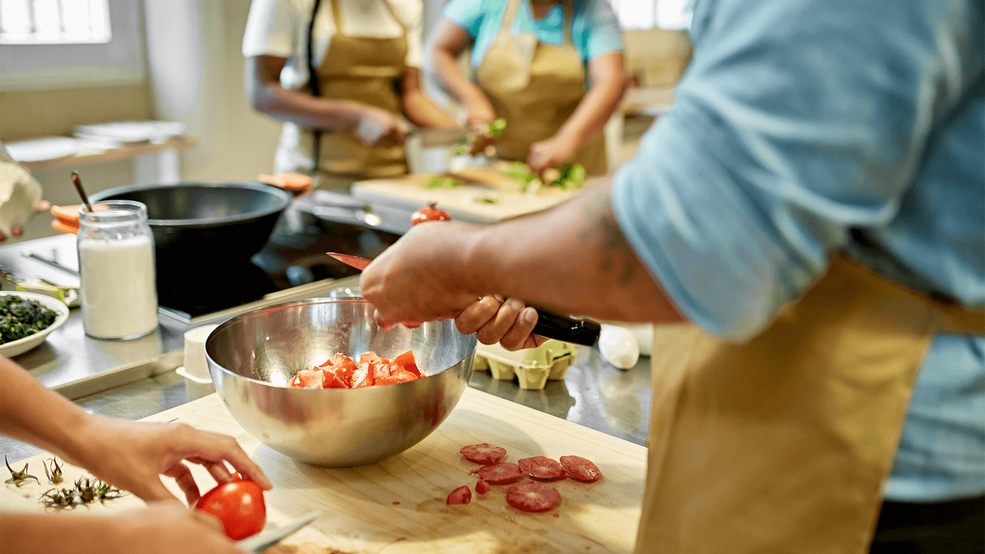 Students cutting vegetables in a class setting