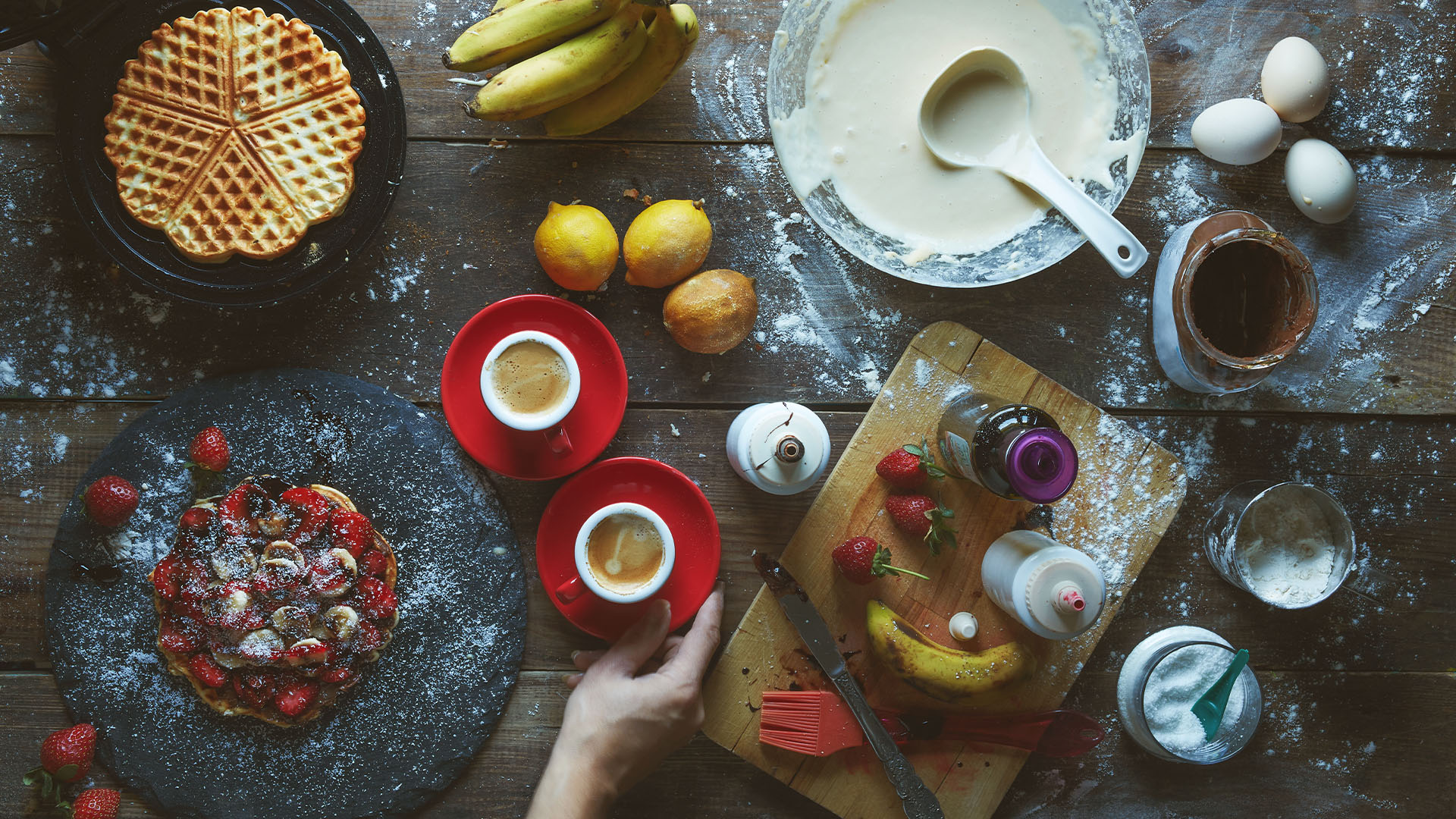 Overhead view of waffles, fruit and coffee on a table