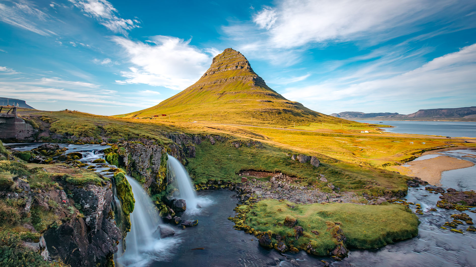 Kirkjufell mountain and waterfall lit by the sun