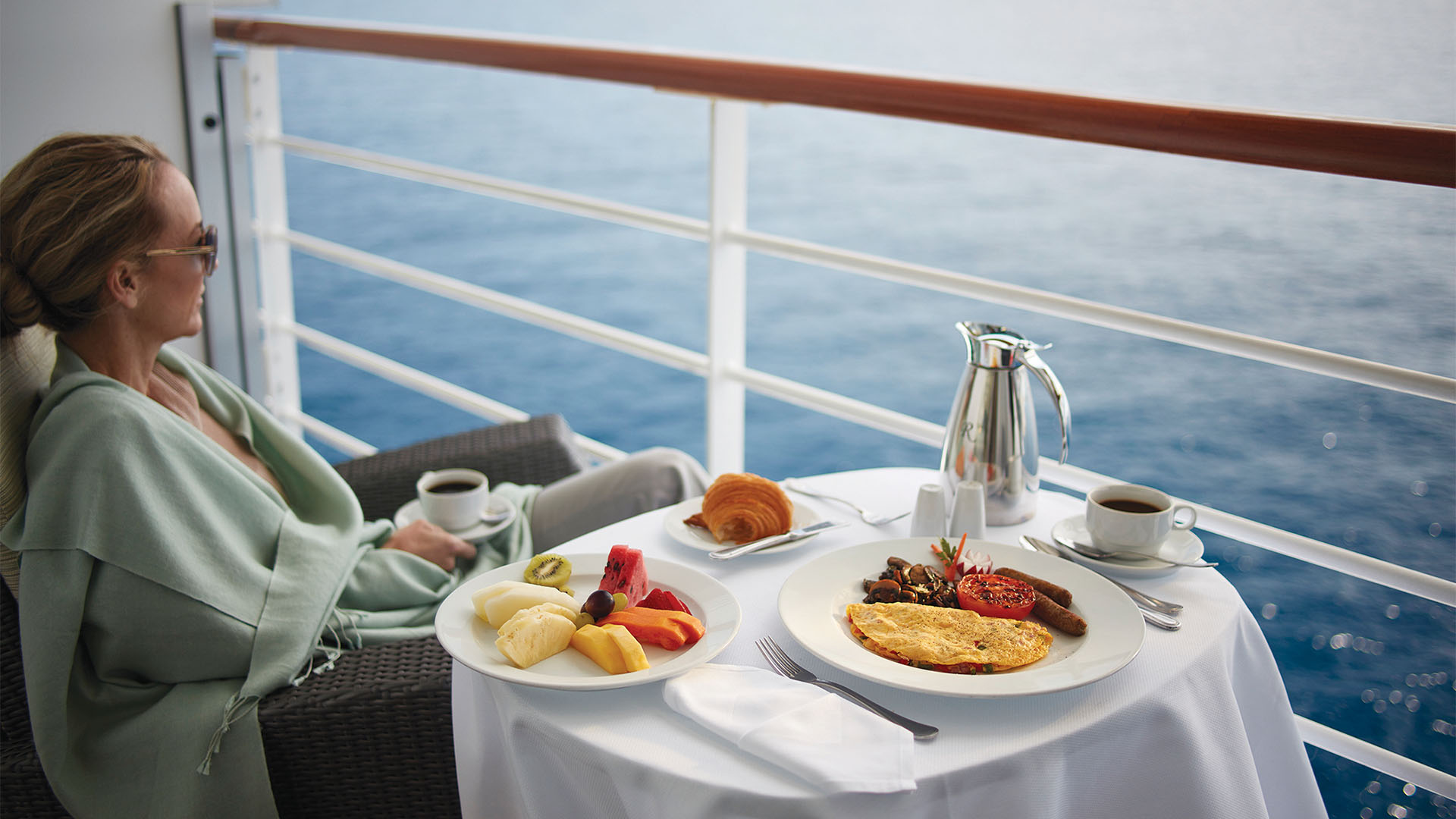A traveller enjoying a breakfast on a cruise ship balcony 