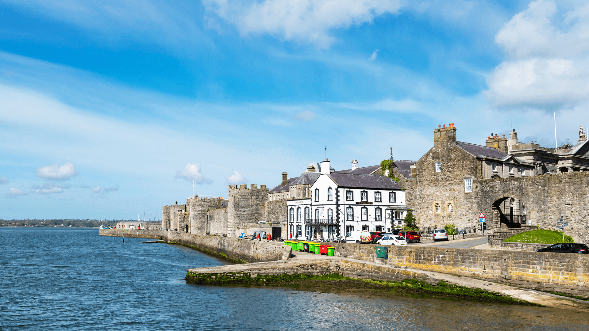 Stone buildings along a town seawall in North Wales