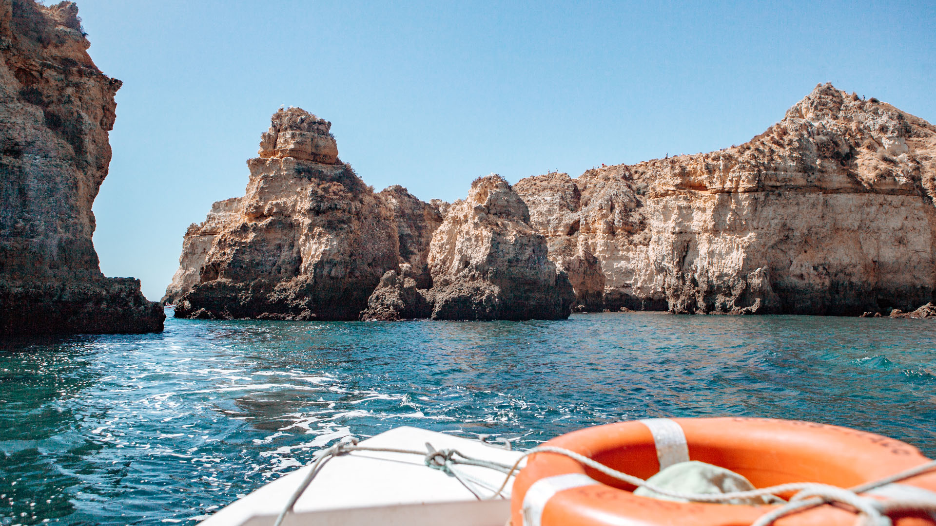 View from a boat of dramatic rock formations in the sea