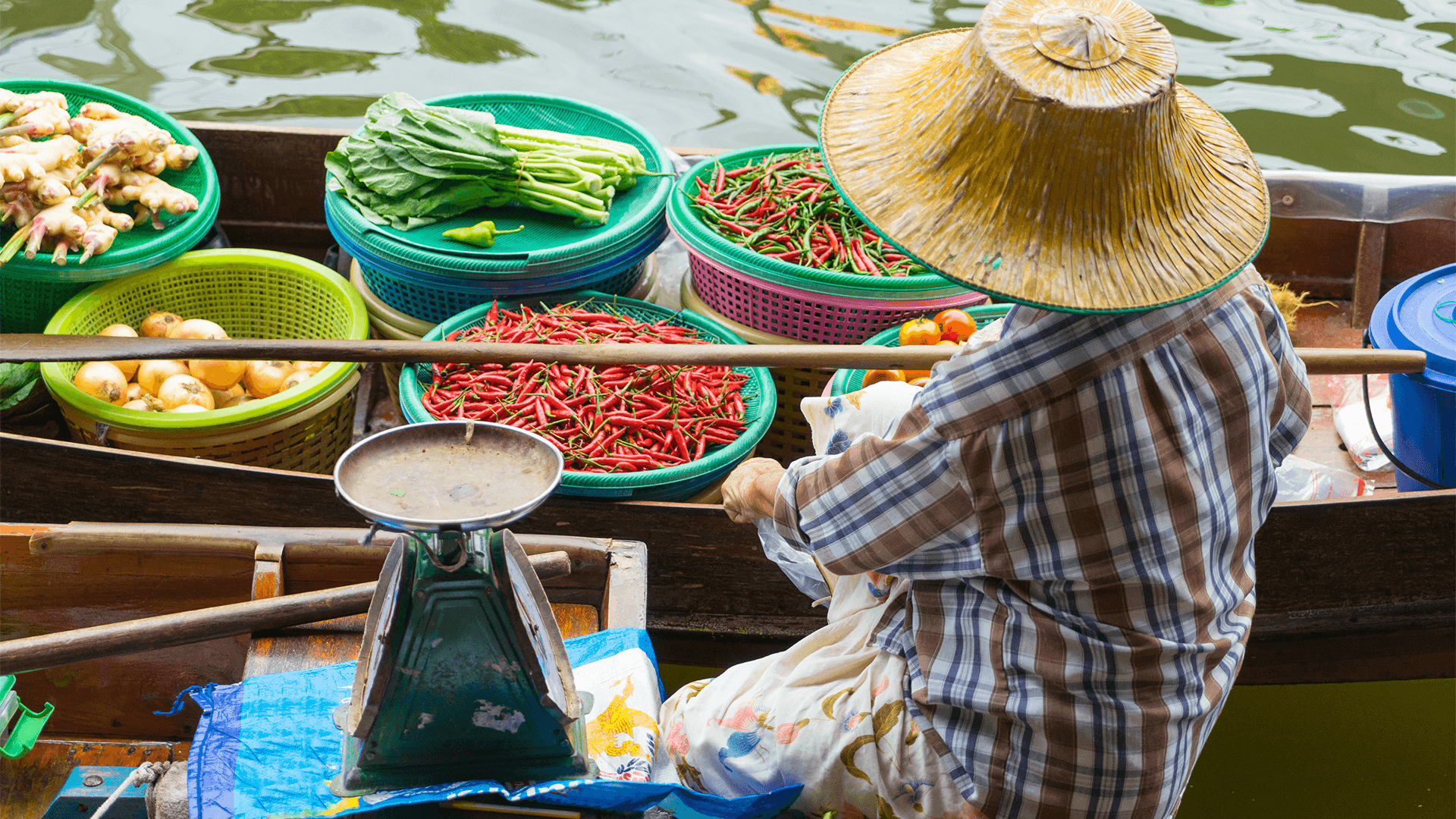 Thai vendors selling produce from boats on the river