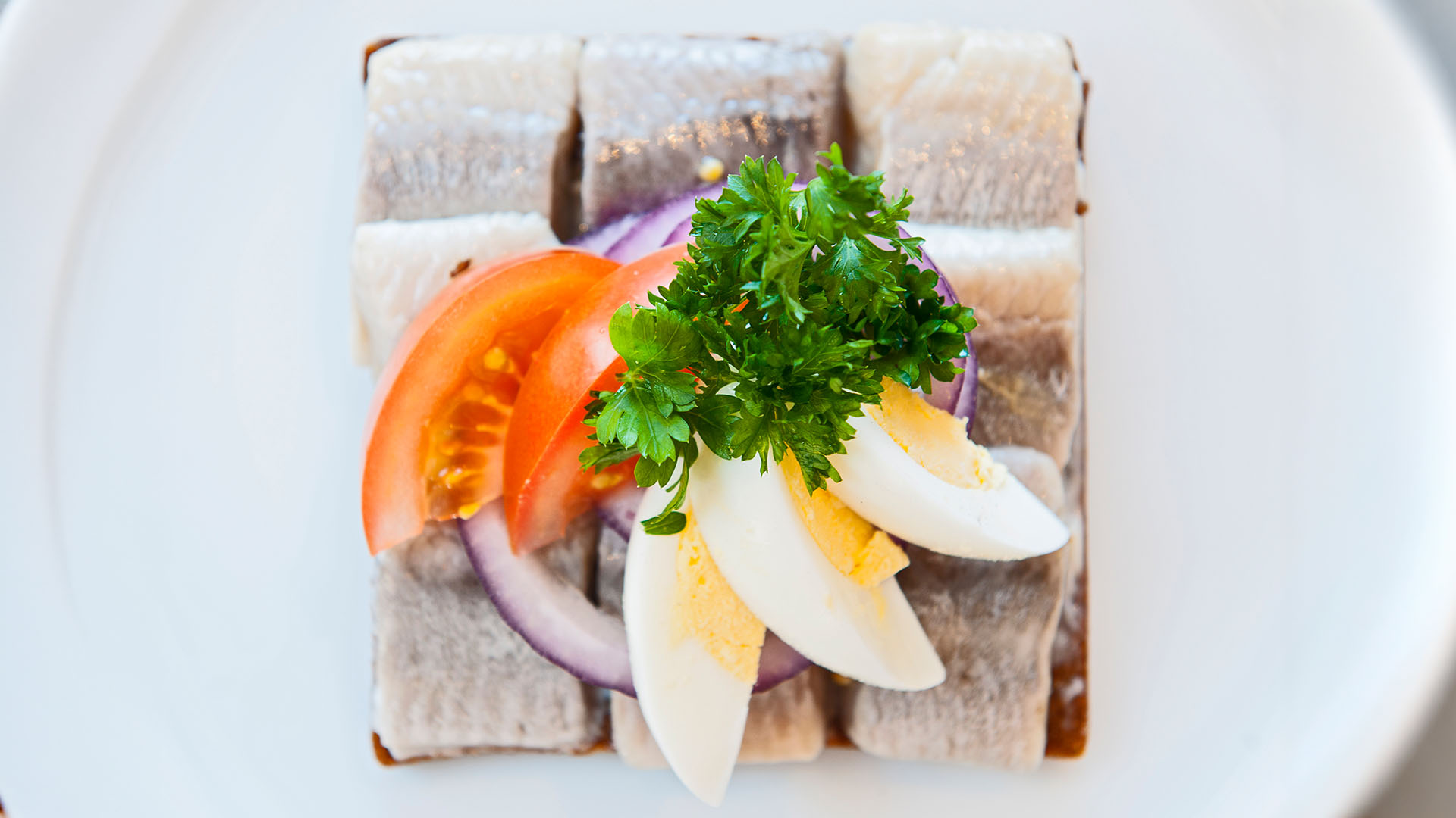Close up of smørrebrød with herring on Icelandic rye bread