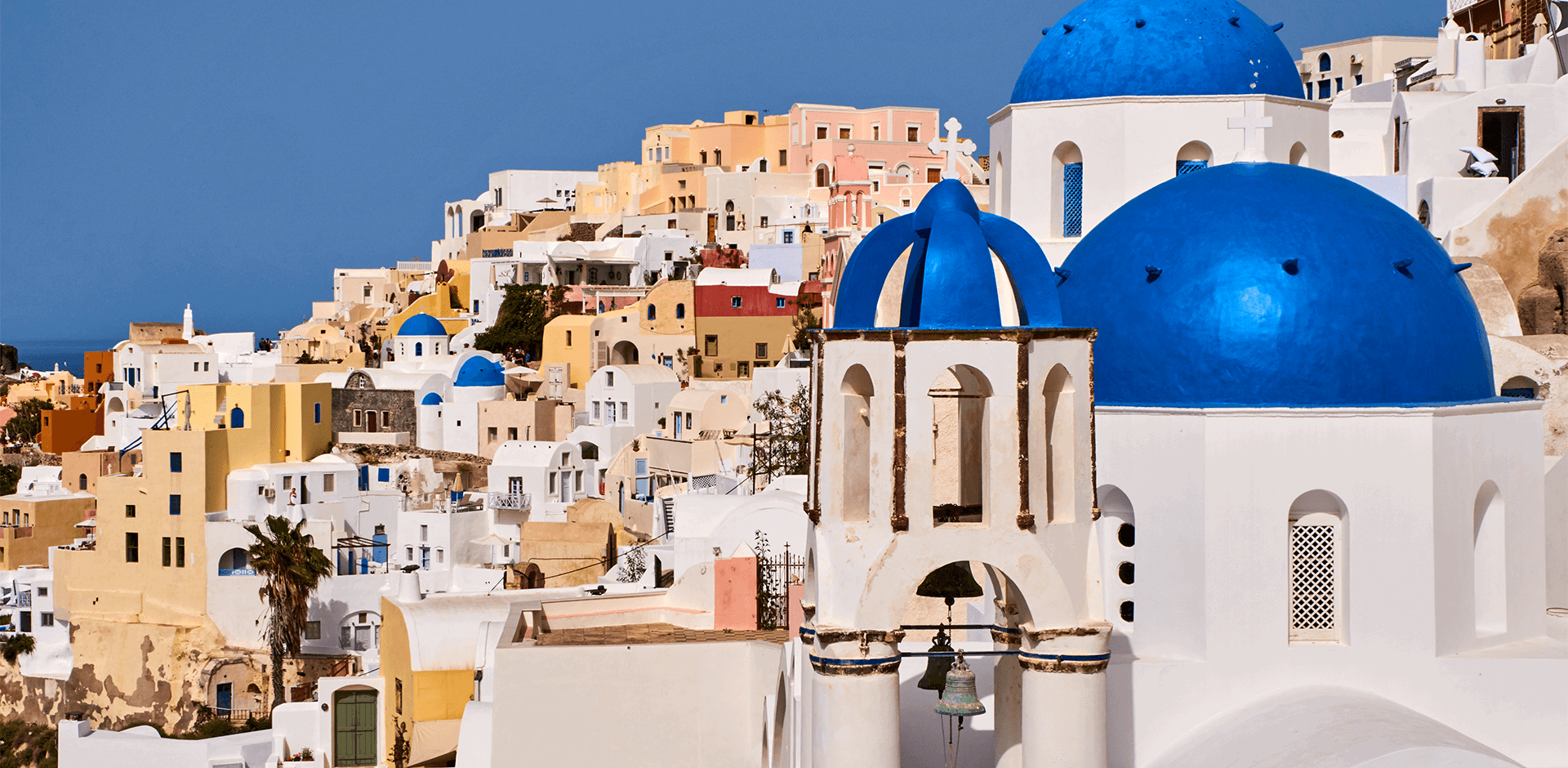 Whitewashed buildings with bright blue church domes